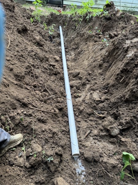 New sewer line laid in a trench at a home